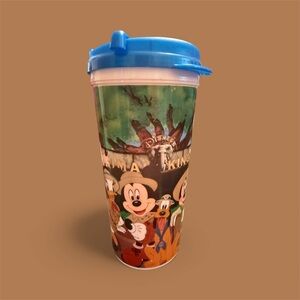 Disney Parks Animal Kingdom Mug with Blue Lid and Colorful Characters